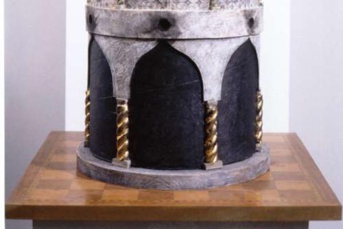 A model or sculpture of a building with a dome on top of a chess board 