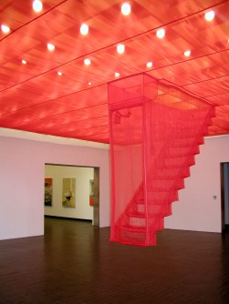 In a room a sheer fabric ceiling is installed, with a fabric staircase coming down from the ceiling