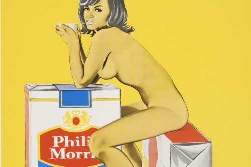 A naked woman in a yellow hue sits on a giant cigarette box and leans on another one in a yellow color field