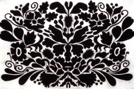 Symmetrical black pattern of birds, flowers, and the like
