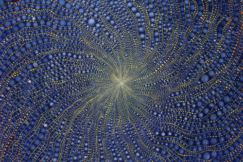 An abstract picture of thousands of blue, red, yellow, white, circles spiral into a white center