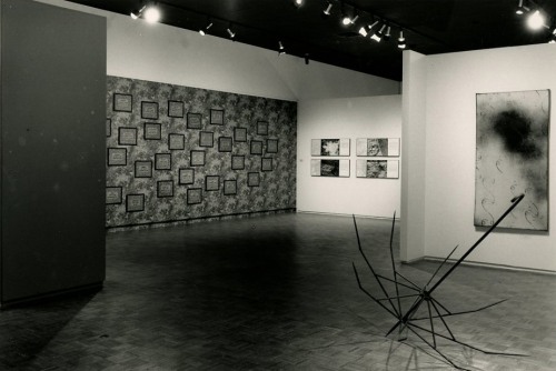 A black and white image of a gallery space