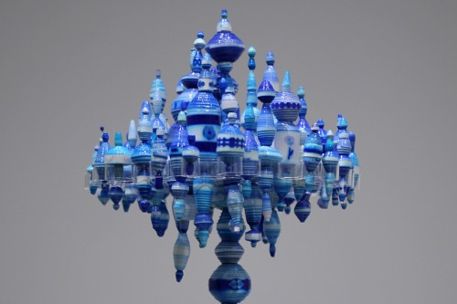 A glass sculpture that slightly resembles a lamp in white and blue