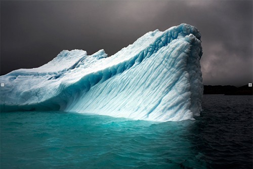 33 Degrees: Breaching Iceberg, Greenland, by Camille Seaman