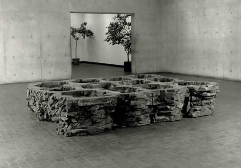 Installation view of a wood sculpture in the List lobby